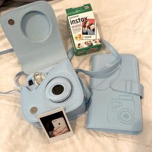 Fujifilm instax mini with case, strap, film, and a photo album.